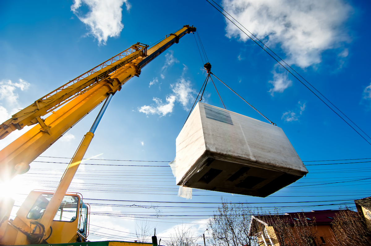 Industrial,Crane,Operating,And,Lifting,An,Electric,Generator,Against,Sunlight Wireless mounted camera