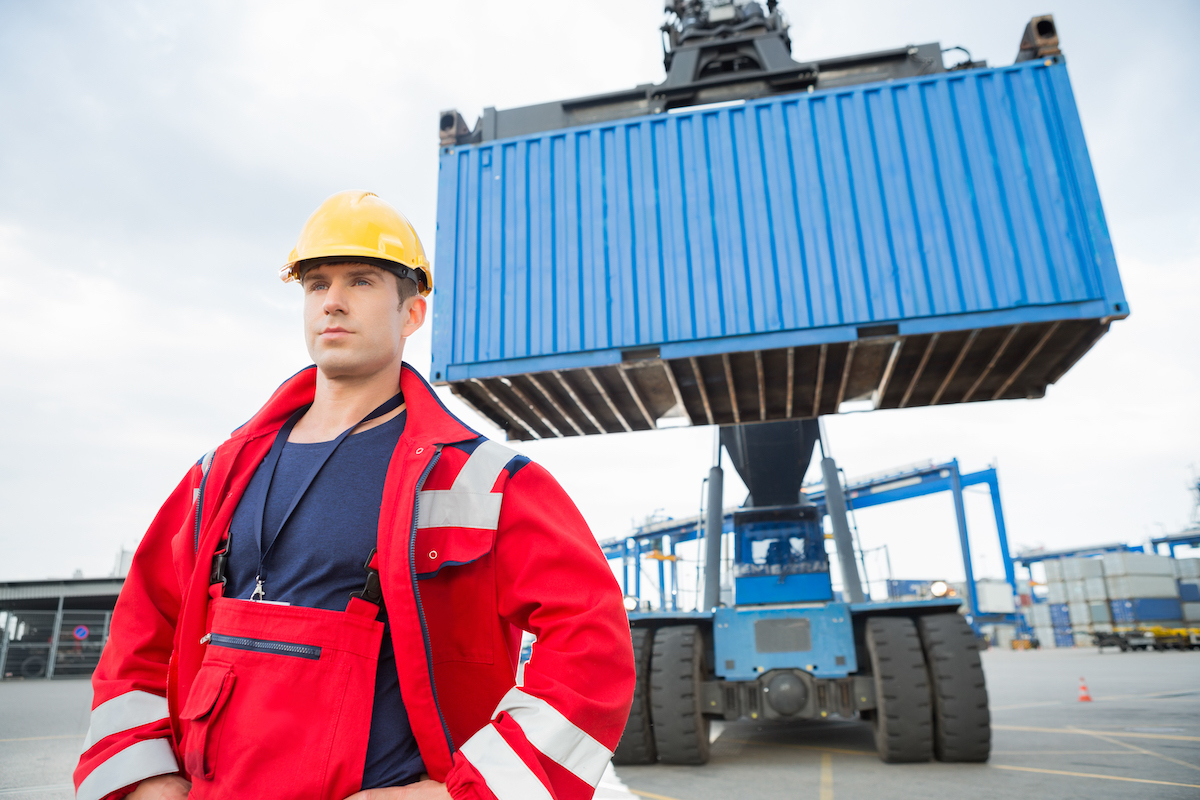Confident,Male,Worker,Standing,In,Front,Of,Freight,Vehicle,At Wireless mounted camera