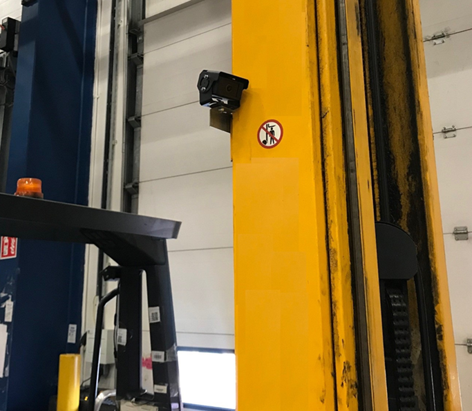 Mast mounted camera on a yellow forklift truck.